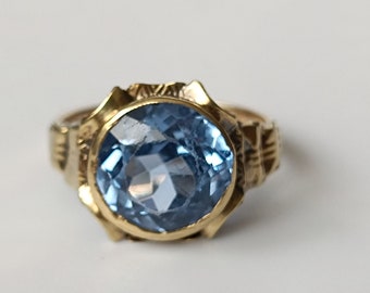 An Antique 14ct gold Ring with a bright facetted blue Paste stone