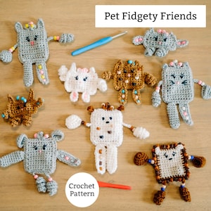 May include: A collection of handmade crochet fidget toys in various colors and designs, including cat and bear shapes. The toys are arranged on a wooden surface with a crochet hook and the text "Pet Fidgety Friends". A crochet pattern is also visible.