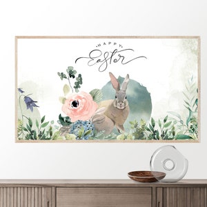 May include: A watercolor painting of a bunny rabbit with a floral arrangement. The bunny is brown and gray with long ears. The flowers are pink, blue, and green. The text "Happy Easter" is written in black cursive above the bunny.