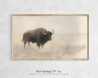 May include: A framed print of a black bison standing in a misty field. The bison is facing to the left and has large horns. The background is a soft, muted brown colour.