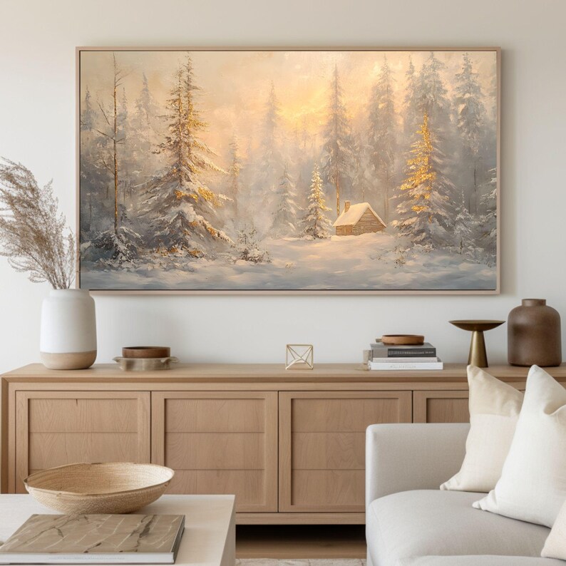 May include: A painting of a snowy forest scene with a small cabin in the distance. The trees are covered in snow and the sun is shining through the branches. The painting is framed in a light wood frame.