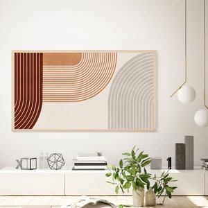 May include: A framed abstract art print with geometric shapes in shades of red, orange, and gray. The print is hanging on a white wall above a white shelf with decorative objects.