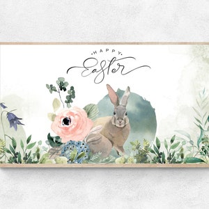 May include: A watercolor illustration of a rabbit surrounded by flowers and greenery. The text "Happy Easter" is written in cursive above the rabbit.