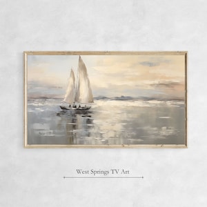 May include: A framed painting of a sailboat on a calm body of water. The sky is a soft yellow and the water is a light blue. The sailboat is white with a brown hull. The painting is in a light wood frame.