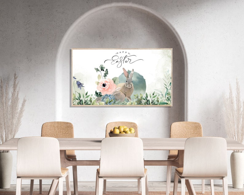 May include: A watercolor painting of a bunny rabbit with the text "Happy Easter" in a white frame hanging on a wall above a wooden table with four chairs.