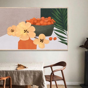 May include: A framed illustration of a bowl of oranges with a green leafy plant and yellow flowers in a vase. The background is a light gray color.