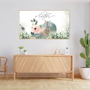 May include: A watercolor print featuring a rabbit with a pink flower and green foliage. The print has the text "Happy Easter" written in cursive.