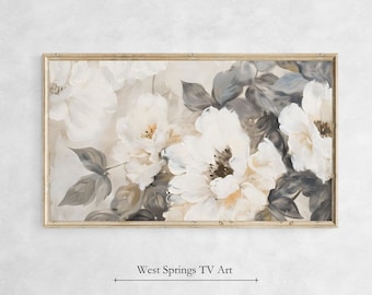 Puede incluir: Una pintura enmarcada de flores blancas con hojas grises. Las flores están pintadas en un estilo suave y romántico. La pintura está enmarcada en un marco de madera simple.