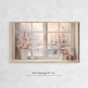 Puede incluir: Una ventana de estilo vintage con vista a una ciudad cubierta de nieve. La ventana está decorada con una planta en maceta y pequeños objetos decorativos. La ventana está enmarcada en un marco de madera claro.