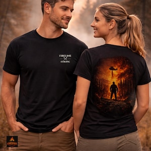 May include: Black t-shirts with the text "FIRELINE STRONG" and a graphic of crossed axes. The back of one shirt features a firefighter silhouette in front of a wildfire with a helicopter above. The shirts are worn by a man and a woman.