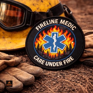 May include: A round black patch with the words "FIRELINE MEDIC" and "CARE UNDER FIRE" encircling a blue star of life emblem with a white staff. The patch is surrounded by flames and a forest scene. A yellow helmet and brown gloves are in the background.