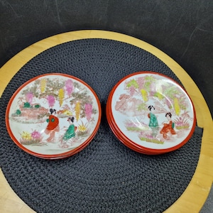 Vintage Japanese Kutani Geisha Saucers - 2 Different Type, Hand Painted, Red Trim. This exquisite set of two vintage Japanese Kutani ...