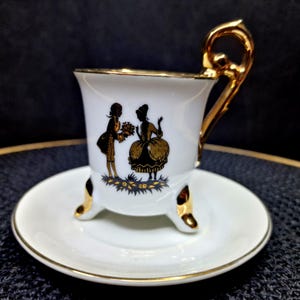 Vintage Demitasse Cup & Saucer Set - Golden Rim, Dancing Couple Silhouette, 4 oz. This exquisite vintage demitasse cup and saucer set ...