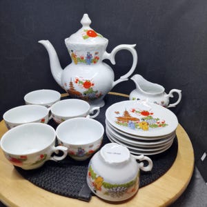 Vintage Chinese Porcelain Tea Set - Hand Painted Figures & Pagoda Design. This exquisite vintage Chinese porcelain tea set features ...