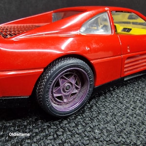 Burago Model Car Ferrari 348 TB (1989) in red color, a 1/18 scale model Die Cast, used and the wheels are painted. Issues shown in images.
