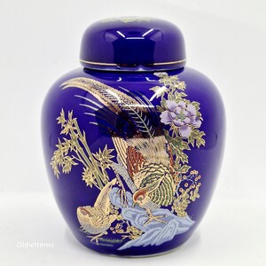 May include: A cobalt blue ceramic jar with a lid, decorated with gold and white painted details of a pheasant and bamboo.