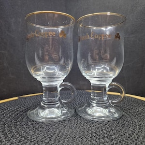 Vintage Irish Coffee Glass Mugs | Gold Rim & Shamrock, Set of Two. A pair of vintage, clear glass Irish Coffee mugs with a gold rim and ...
