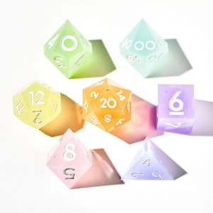 May include: A set of six pastel-colored dice with white numbers. The dice are a d4, d6, d8, d10, d12, and d20.