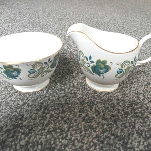 A lovely Queen Anne bone china guilded  milk jug and sugar bowl C1960s manufactured by Ridgway potteries