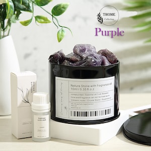 May include: Purple amethyst crystals in a black metal jar with a white label that reads "Nature Stone with fragrance oil 10ml/0.35 fl.o.z compounded: Essential oil from Sweden Love and Fragrance can not be lived up to Volcanic rocks / Crystal Stone / Essential oil eau de parfum/vaporisateur natural essential oil". A small bottle of essential oil and a box are also pictured.