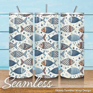 May include: Three skinny tumblers with a seamless pattern of blue, orange, and white fish. The fish have various patterns and are set against a dotted background. Each tumbler has a silver lid and a straw. The word "Seamless" is at the bottom.