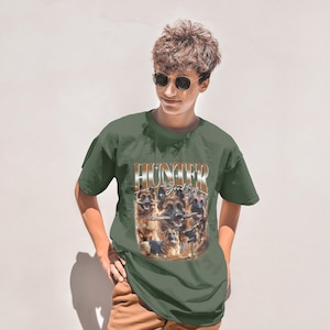 a man wearing a green shirt with a picture of a bunch of animals on it