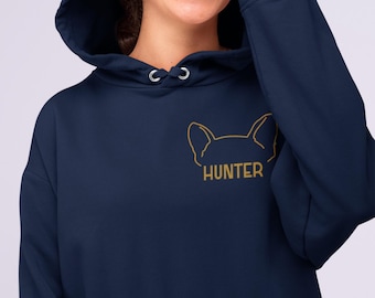 Op de afbeelding: Een marineblauwe hoodie met een goudkleurige lijntekening van dierenoren en de tekst HUNTER op de linkerborst. Het kledingstuk is voorzien van een capuchon met bijpassende marineblauwe trekkoorden en een kangoeroezak aan de voorzijde.