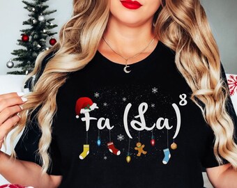 May include: Black t-shirt with a white snowflake design and the text "Fa (La) ⁸" with a red Santa hat and hanging ornaments.