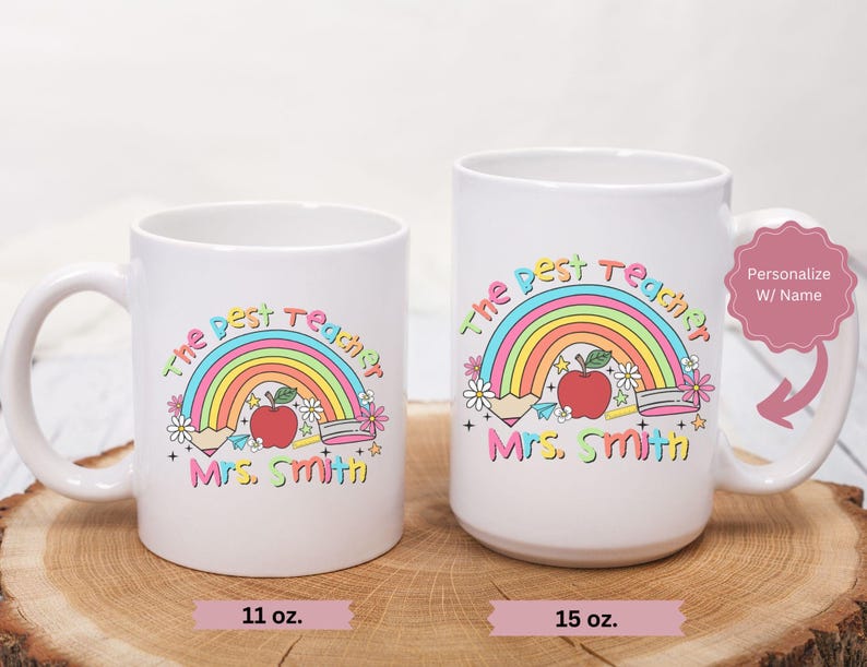 May include: Two white ceramic mugs with a rainbow, apple, and pencils design. The text on the mugs reads "The Best Teacher" and "Mrs. Smith". The mugs are available in 11 oz and 15 oz sizes.