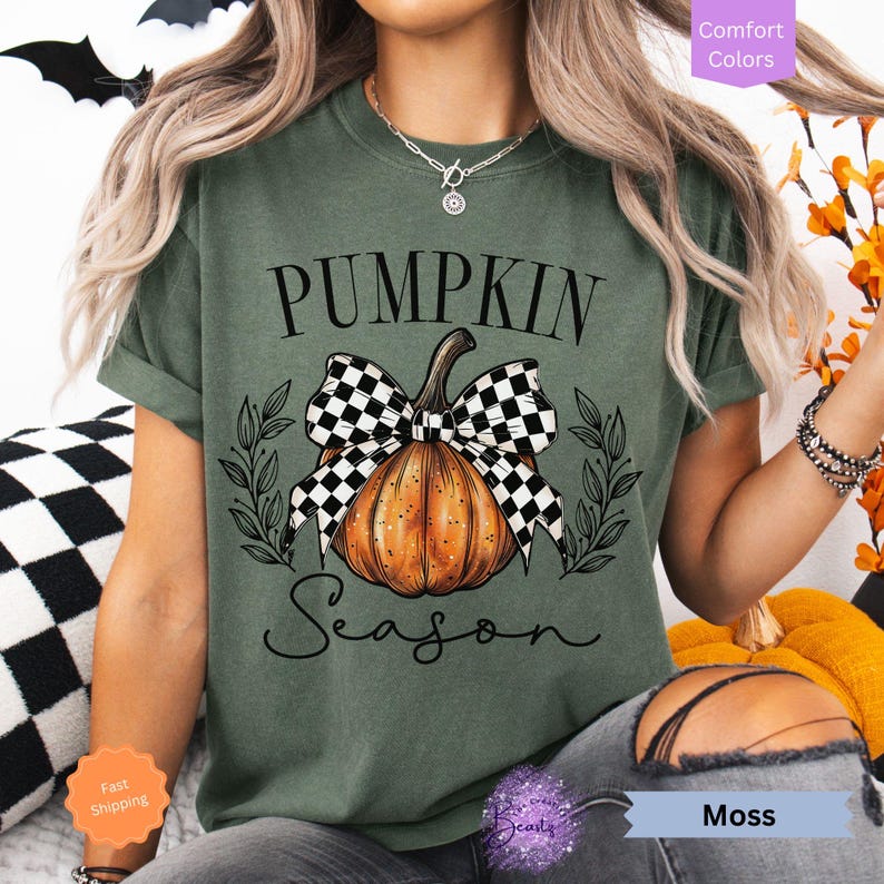 May include: A green t-shirt with a black and white checkered bow on a pumpkin with the text "Pumpkin Season".