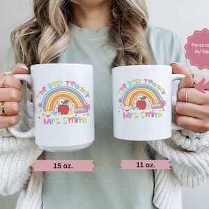May include: White ceramic mug with a rainbow design and the text "The Best Teacher" with a name. The mug is available in 11 oz and 15 oz sizes.