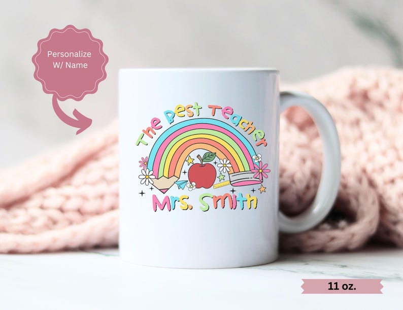 May include: White ceramic mug with a rainbow, apple, pencil, and ruler design. The text "The Best Teacher" and "Mrs. Smith" is printed on the mug. The mug is 11 ounces.