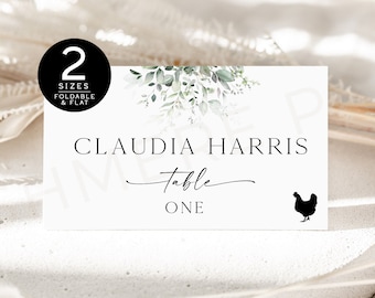 May include: White table card with green watercolor leaves and a black silhouette of a chicken. The text reads "Claudia Harris Table One".