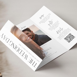 May include: A white wedding invitation featuring a photograph of a couple on the front. The invitation includes the text "The Wedding Day" and the date of the wedding. The reverse side of the invitation provides details about the wedding ceremony, reception, and RSVP information.