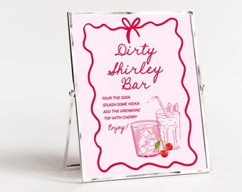 May include: A pink sign with the words "Dirty Shirley Bar" in a decorative font. The sign includes instructions for making the cocktail and illustrations of the drink. The sign is in a silver frame.