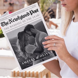 K&ouml;nnte beinhalten: Ein Schwarzwei&szlig;foto eines Paares an ihrem Hochzeitstag, das auf der Titelseite einer Zeitung mit der Schlagzeile "The Newlywed Post: The Wedding of the Year!" abgebildet ist. Das Paar wird als Amelia & Oliver identifiziert, mit dem Text "Begin their journey" unter ihren Namen.