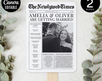 May include: Black and white newspaper-style wedding program fan with the headline "The Newlywed Times" and the text "Amelia & Oliver Are Getting Married". The fan includes a photo of the couple and a list of wedding party members, order of events, and a message to guests.