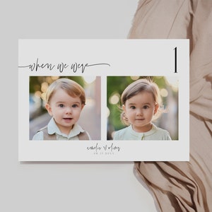 May include: A white card with the text "when we were" and the number "1" in black script. Two photos of young children are on the card, one of a boy and one of a girl. The text "emily + oliver" and the date "08.07.2023" are also on the card.