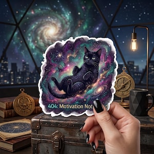 May include: A die-cut sticker featuring a black cat floating in a vibrant purple, pink, and teal nebula. The cat has a starry coat and is positioned against a cosmic background. The text "404: Motivation Not Found" is printed in white at the bottom.