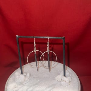 quill in hooped earrings