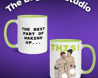 May include: Two white ceramic mugs with green accents. One mug has the text "THE BEST PART OF WAKING UP..." in black. The other mug has an illustration of two men and the word "THIS!" in green.