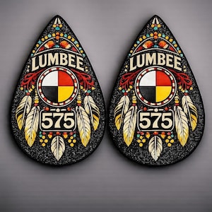 May include: Pair of black teardrop-shaped Lumbee earrings. Each earring features a central design with a white, red, black, and yellow circle, the word "LUMBER" and the number "575". Gold and white feathers are also included.