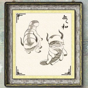 Puede incluir: Obra de arte enmarcada con dos criaturas estilizadas en tinta negra y blanca. Las criaturas, que se asemejan a bisontes con cuernos, están representadas sobre un fondo crema con caracteres chinos. El marco es una mezcla de gris y dorado.