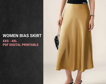 May include: A golden-yellow bias skirt with a slight sheen. The skirt is paired with a black top and black shoes. Text on the left reads "WOMEN BIAS SKIRT XXS - 4XL PDF DIGITAL PRINTABLE" with the "Alaiana PATTERN" logo below.