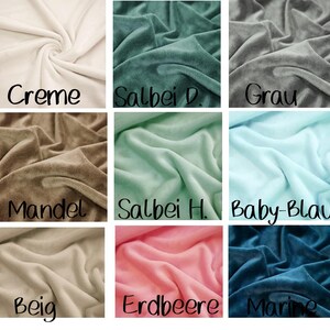 May include: Close-up of nine swatches of soft, plush fabric in various colors. Colors include cream, sage green, gray, almond, mint green, baby blue, beige, pink, and navy blue. Each swatch has a handwritten label.