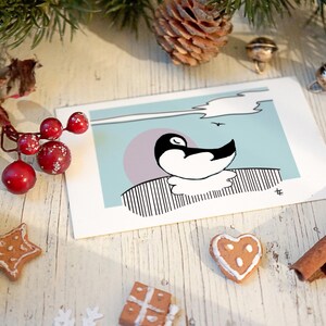 Mignonne carte de Noël pingouin endormi sur une carte recyclée respectueuse de l'environnement