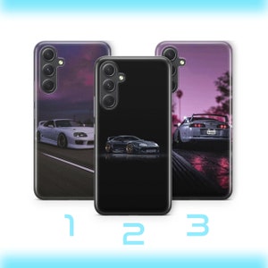 Könnte beinhalten: Drei Handyhüllen mit Autodesigns. Die erste Hülle zeigt ein weißes Auto auf einer Straße mit lila Himmel. Die zweite Hülle ist schwarz mit einem dunkelgrauen Auto. Die dritte Hülle zeigt ein graues Auto auf einer Straße mit lila Himmel. Die Zahlen 1, 2 und 3 befinden sich unten.