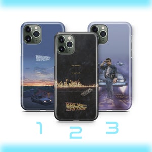 May include: Three different phone cases featuring the Back to the Future movie logo and imagery. The first case has a sunset scene with the DeLorean time machine driving away. The second case has a black background with flames and the text "Get ready... to go back." The third case has a blue background with the DeLorean time machine and Marty McFly standing in front of it.