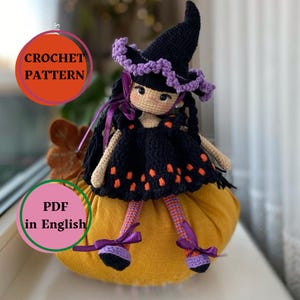 May include: A handcrafted crochet witch doll, featuring a black dress with orange details and a matching hat with purple edging. The doll has black hair and is seated on a yellow pumpkin. The image includes the text "CROCHET PATTERN" and "PDF in English".