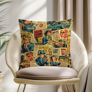 May include: Square throw pillow with a vintage comic book collage design. The pillow features images of people, cars, and newspaper headlines in shades of blue, red, and yellow on a beige background. The pillow is placed on a white chair.